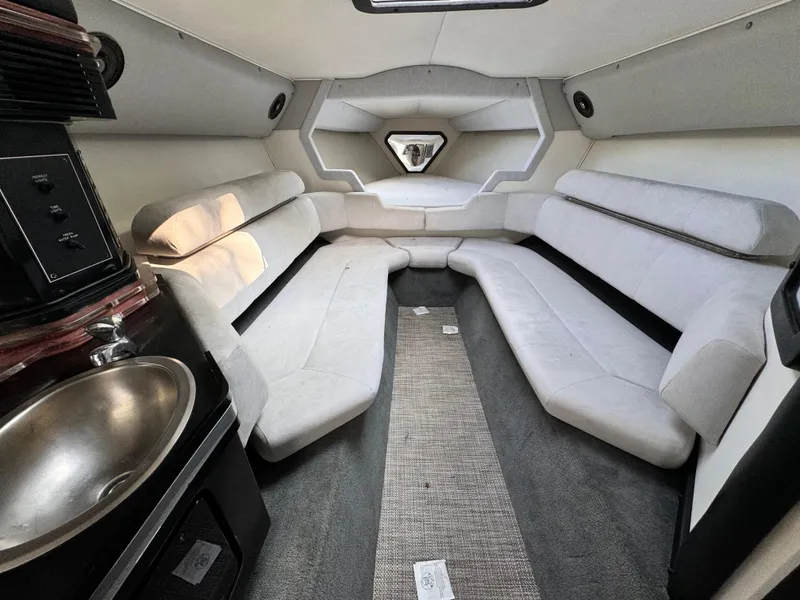 Slide: The Image of Interior of a 1990 Fountain 42 Lightning boat with plush seating and a compact sink. - 31