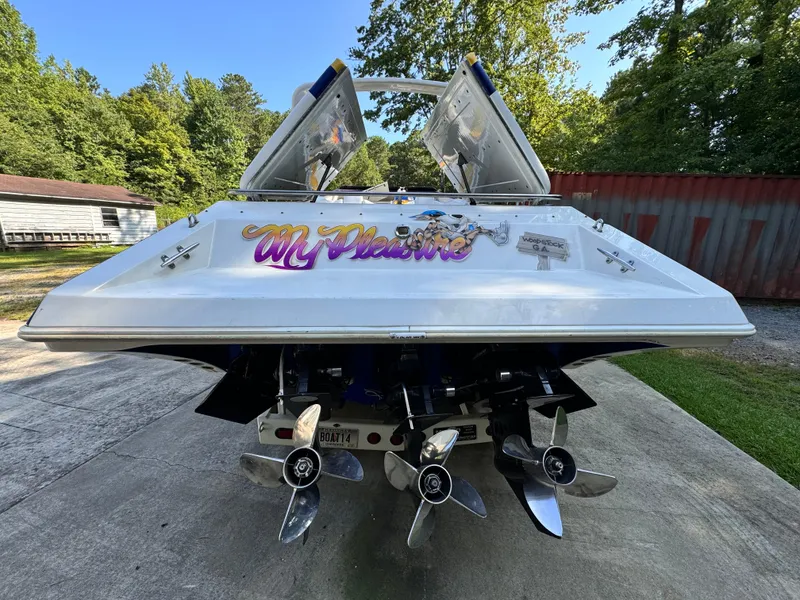 Slide: The Image of 1990 Fountain 42 Lightning speedboat with dual propellers, parked outdoors. - 4