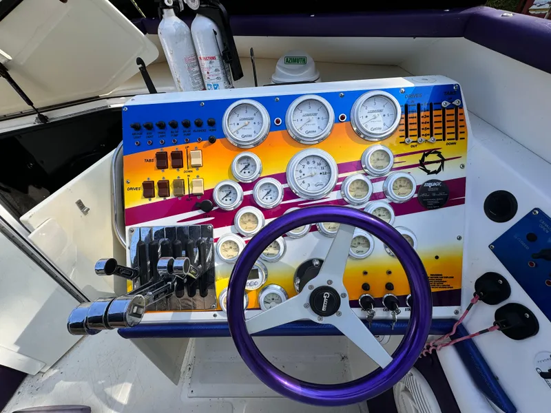 Slide: The Image of Control panel of a 1990 Fountain 42 Lightning boat with gauges and steering wheel. - 41
