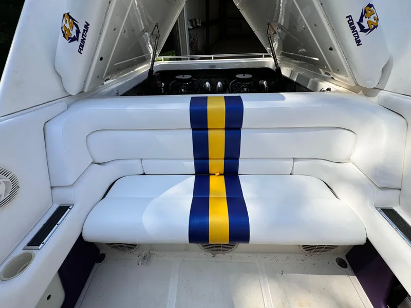 Slide: The Image of 1990 Fountain 42 Lightning boat interior with white seating and blue-yellow stripe. - 42