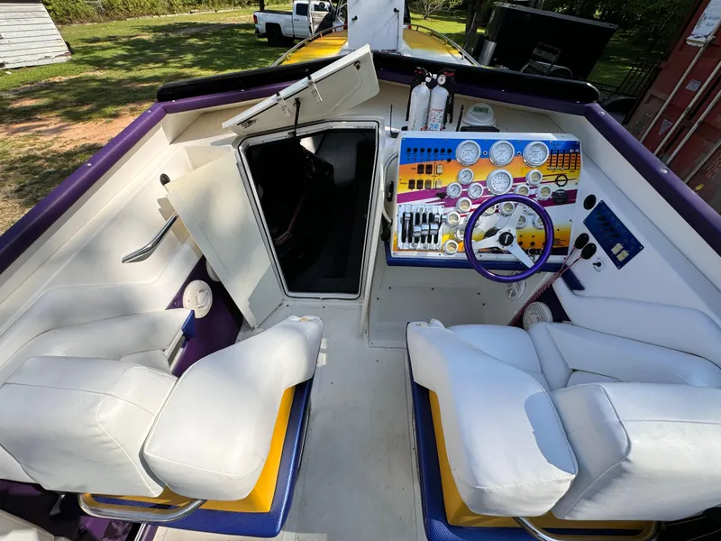 Slide: The Image of Interior of a 1990 Fountain 42 Lightning boat with white seating and colorful dashboard. - 45