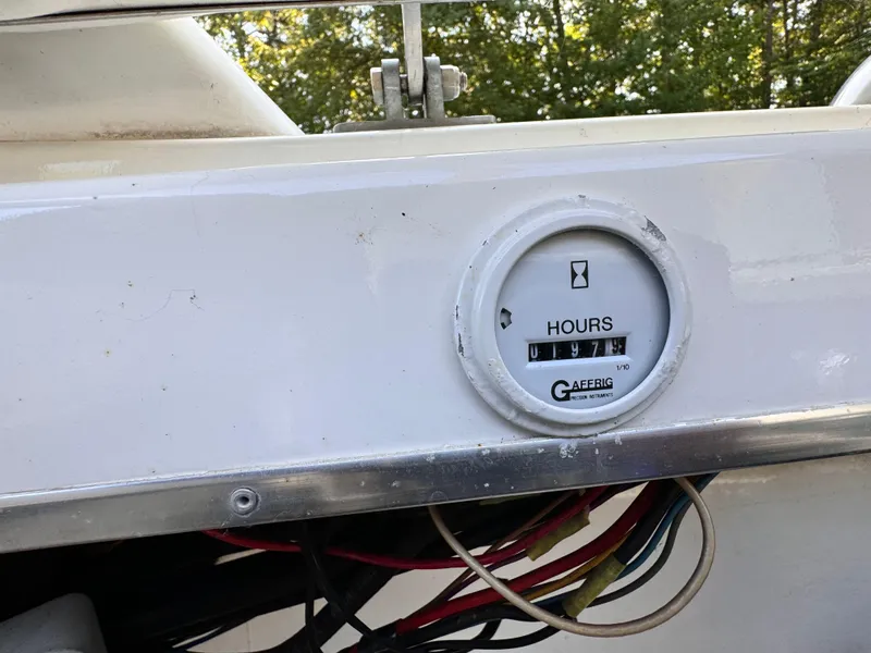 Slide: The Image of Hour meter on a 1990 Fountain 42 Lightning boat dashboard, showing 977 hours. - 48