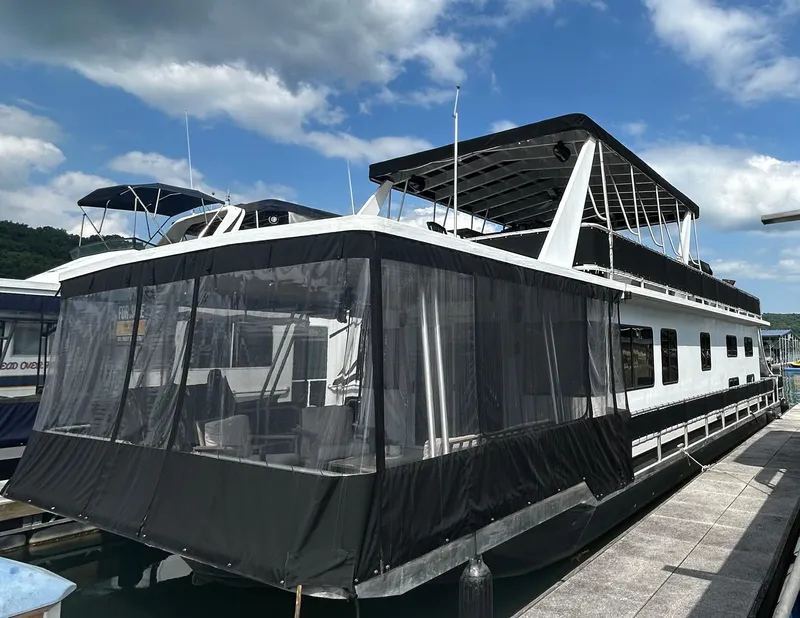The Image of 2004 Majestic houseboat docked under cloudy sky. - 1