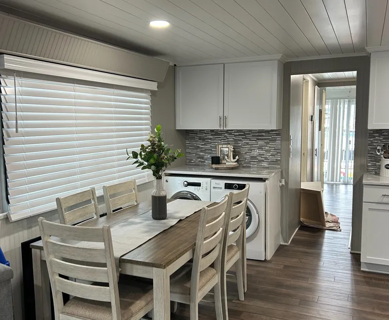 Slide: The Image of Modern 2004 Majestic houseboat interior with dining area, washer, and stylish decor. - 12