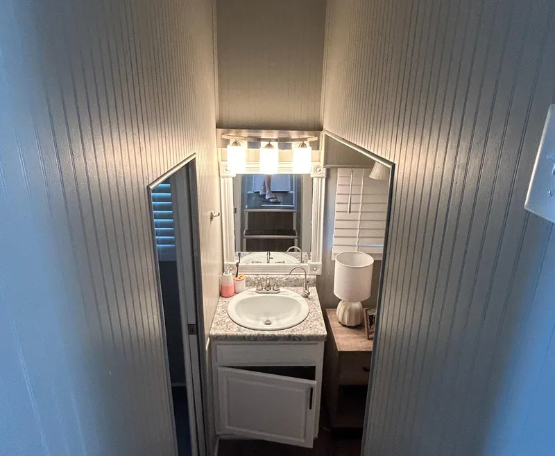 Slide: The Image of Compact bathroom on 2004 Majestic houseboat with sink, mirror, and lighting. - 15