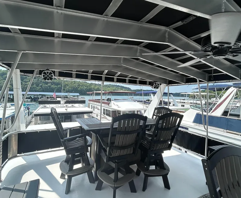 Slide: The Image of 2004 Majestic Houseboat deck with chairs and table, overlooking marina. - 17
