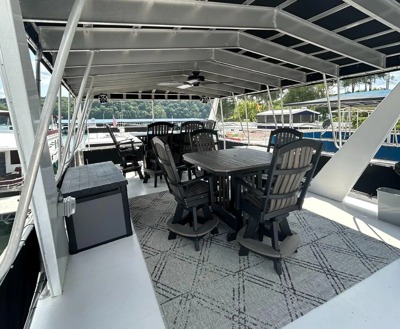 Slide: The Image of Spacious deck of 2004 Majestic Houseboat with outdoor seating and scenic view. - 18