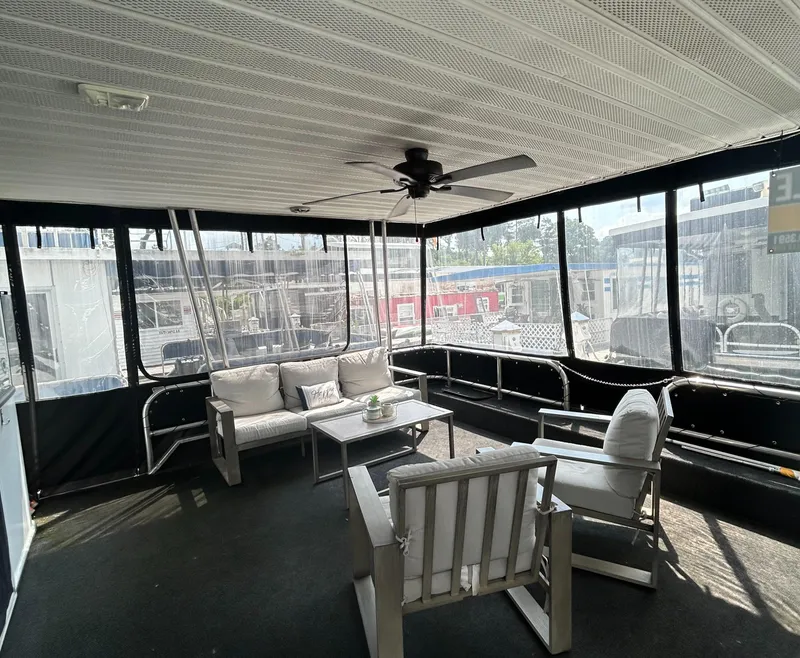 Slide: The Image of Spacious 2004 Majestic houseboat interior with cozy seating and ceiling fan. - 20