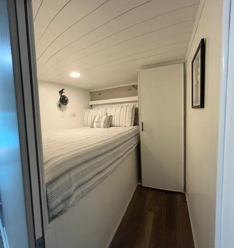 Slide: The Image of Cozy bedroom in 2004 Majestic houseboat with striped bedding and wooden flooring. - 5