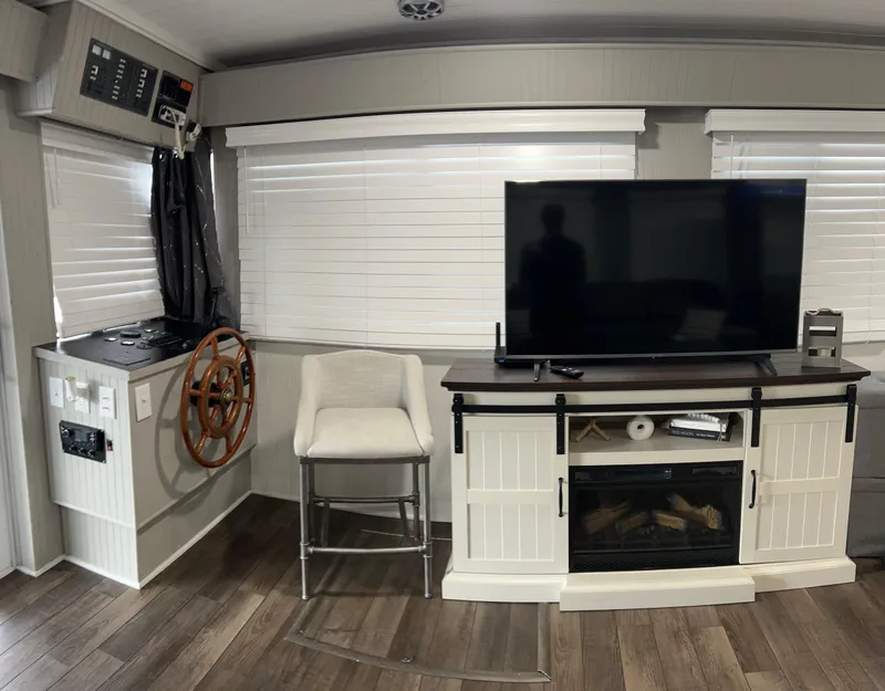 Slide: The Image of Interior of 2004 Majestic houseboat with TV, fireplace, and helm station. - 8