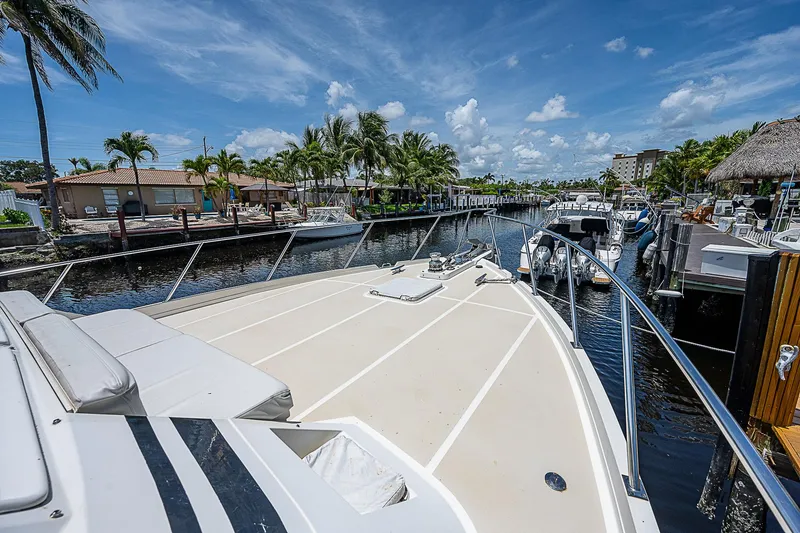 Slide: The Image of Offshore Yachts 62 Pilot House 2000 on a sunny marina with palm trees. - 11