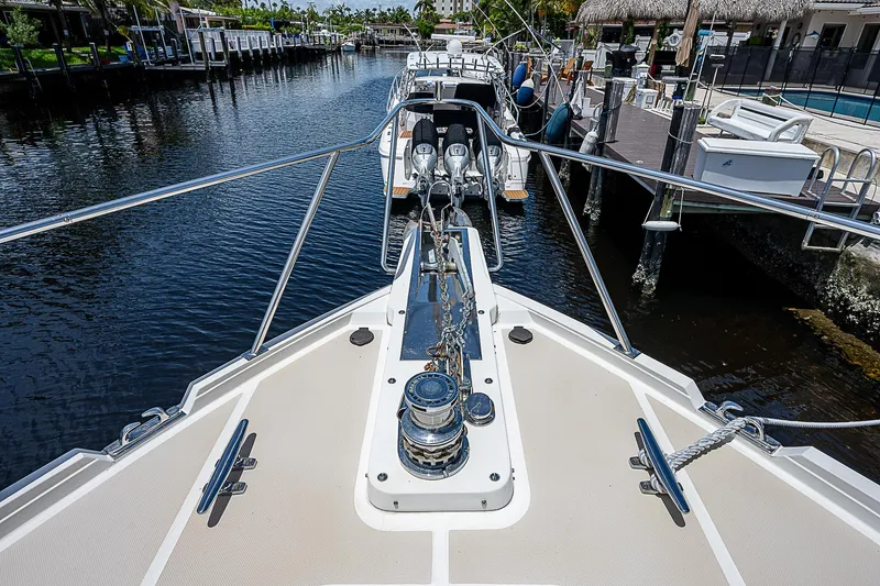 Slide: The Image of Bow view of 2000 Offshore Yachts 62 Pilot House in a marina. - 12