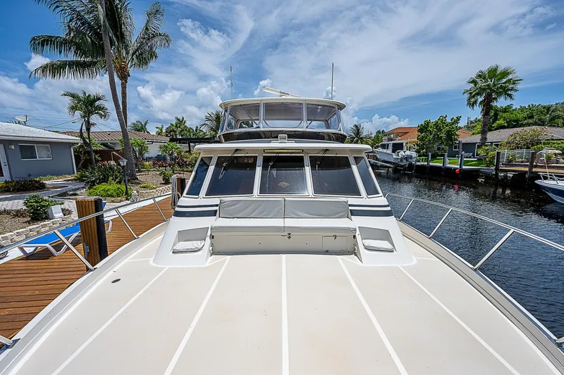 Slide: The Image of 2000 Offshore Yachts 62 Pilot House docked, showcasing sleek design and spacious deck. - 13