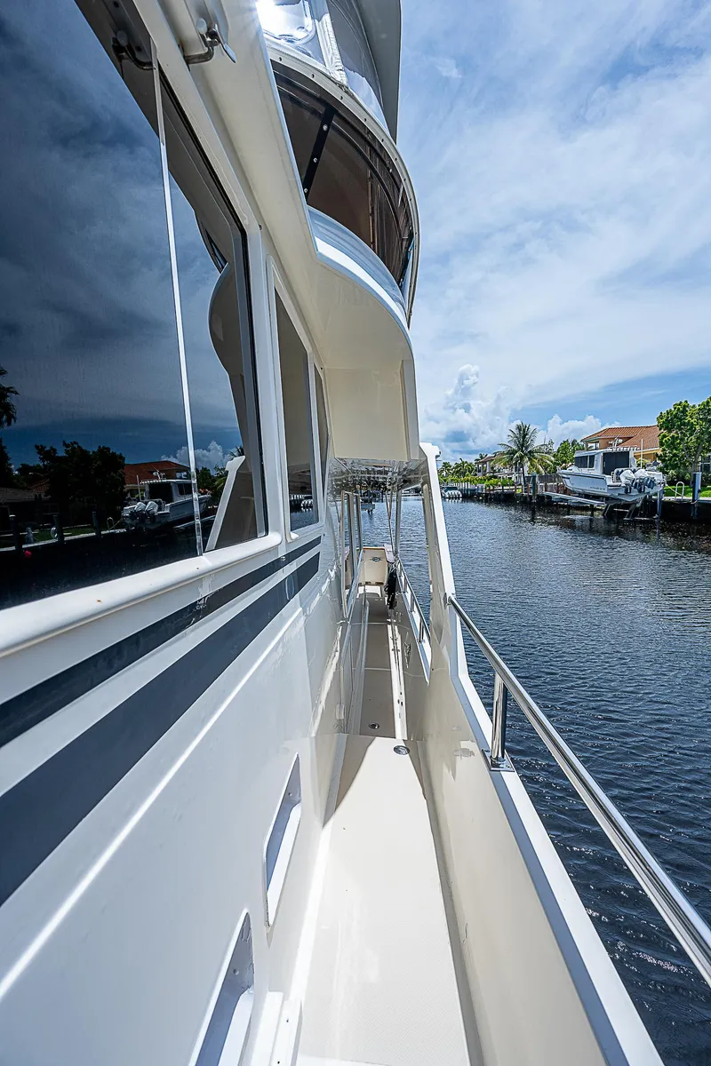 Slide: The Image of Side view of 2000 Offshore Yachts 62 Pilot House on a sunny day. - 16