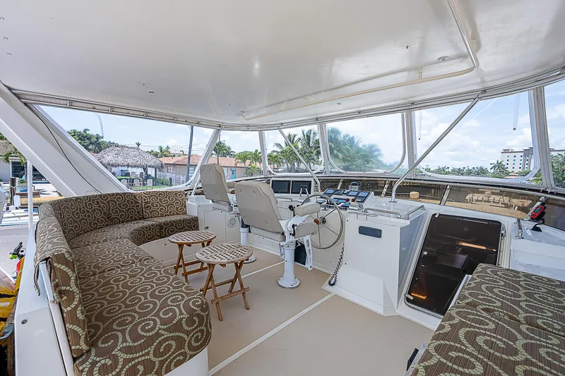 Slide: The Image of Luxurious 2000 Offshore Yachts 62 Pilot House interior with plush seating and helm. - 23