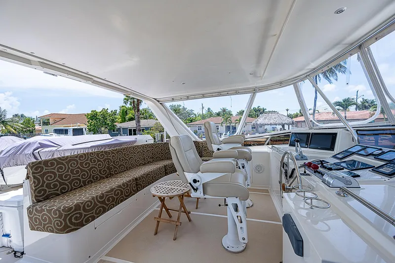Slide: The Image of Luxurious 2000 Offshore Yachts 62 Pilot House interior with helm and seating area. - 25
