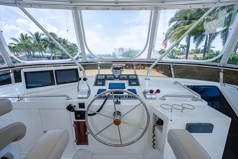 Slide: The Image of Interior view of 2000 Offshore Yachts 62 Pilot House helm with steering wheel and navigation equipment. - 27