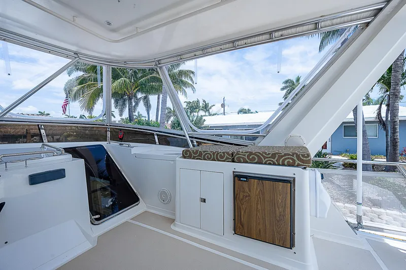Slide: The Image of Interior view of 2000 Offshore Yachts 62 Pilot House with tropical backdrop. - 29