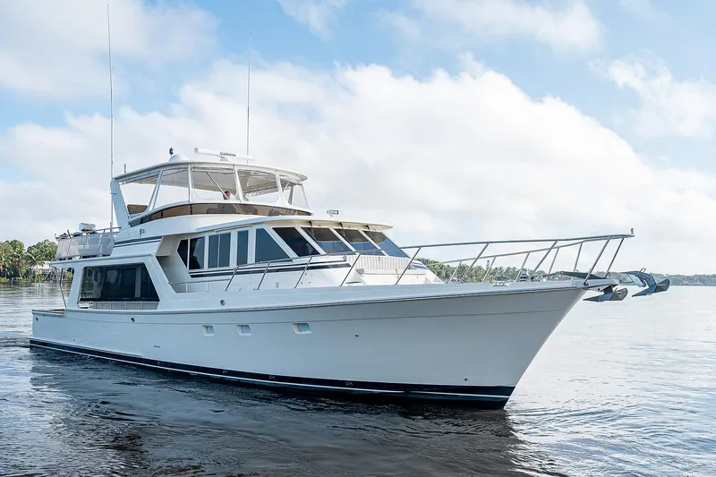 Slide: The Image of 2000 Offshore Yachts 62 Pilot House cruising on calm waters under a clear sky. - 3