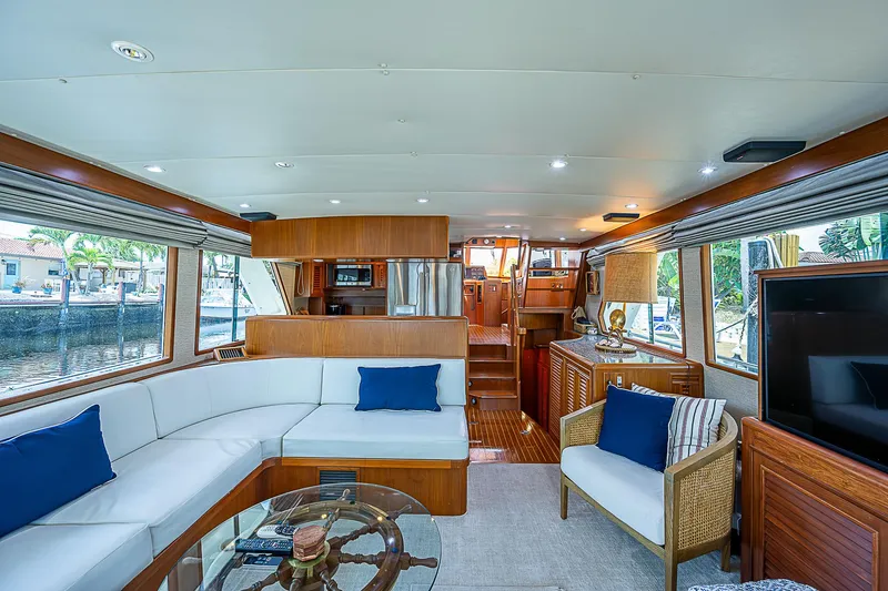 Slide: The Image of Luxurious interior of 2000 Offshore Yachts 62 Pilot House with elegant seating and wood finishes. - 34