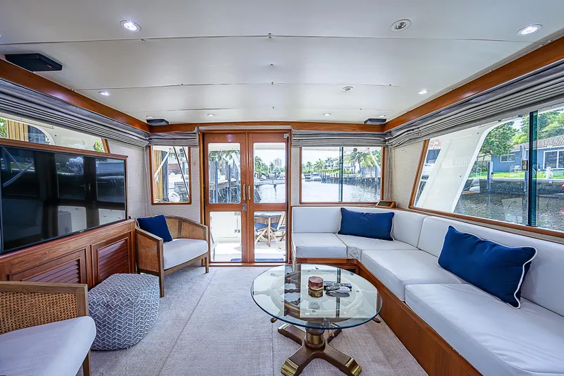 Slide: The Image of Luxurious interior of 2000 Offshore Yachts 62 Pilot House with elegant seating and glass table. - 35