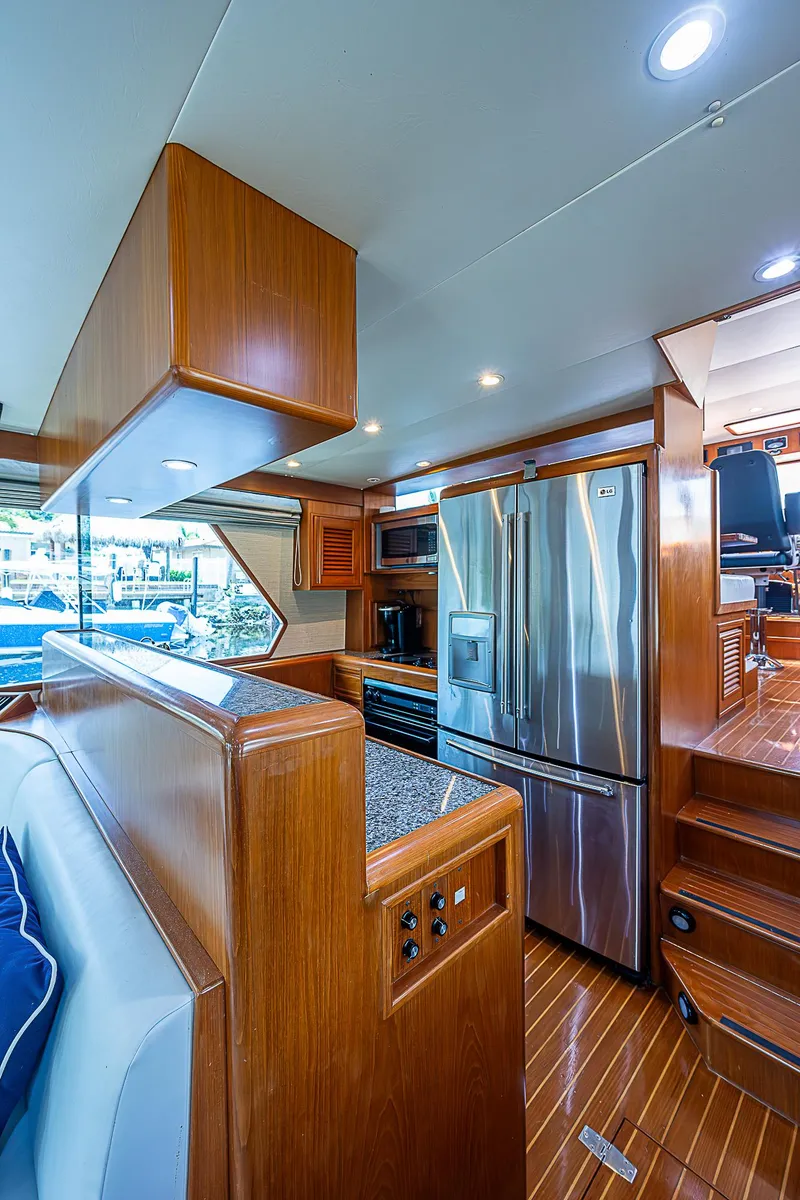 Slide: The Image of Luxurious 2000 Offshore Yachts 62 Pilot House interior with modern kitchen and wood finishes. - 40