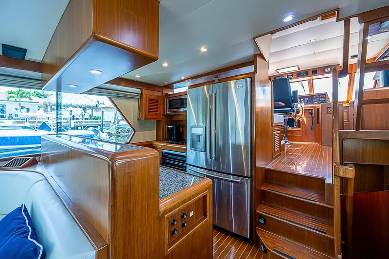 Slide: The Image of Luxurious 2000 Offshore Yachts 62 Pilot House interior with modern kitchen and wood finishes. - 41