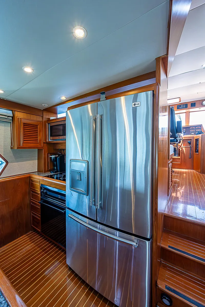 Slide: The Image of Luxurious kitchen interior of 2000 Offshore Yachts 62 Pilot House with stainless steel appliances. - 42