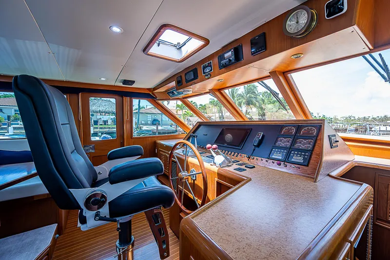 Slide: The Image of Interior of 2000 Offshore Yachts 62 Pilot House, featuring helm and navigation controls. - 47