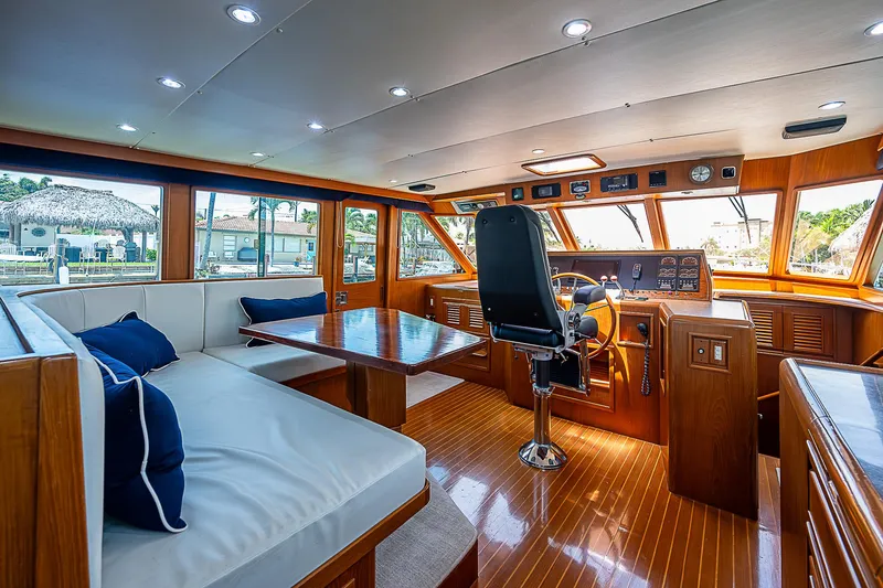 Slide: The Image of Luxurious 2000 Offshore Yachts 62 Pilot House interior with wood finishes and plush seating. - 49