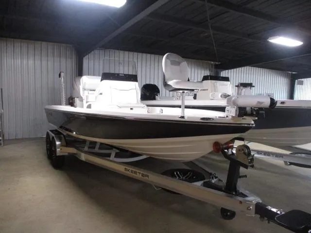 The Image of 2025 Skeeter SX221 boat in a showroom, featuring sleek design and modern amenities. - 1