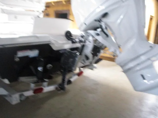 Slide: The Image of 2025 Skeeter SX221 boat engine and propeller in a garage setting. - 6