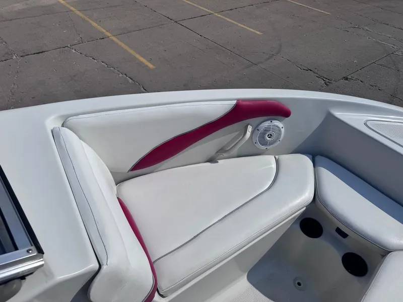 Slide: The Image of 2006 Sugar Sand Oasis boat interior with white and red seating, speaker, and cup holders. - 11