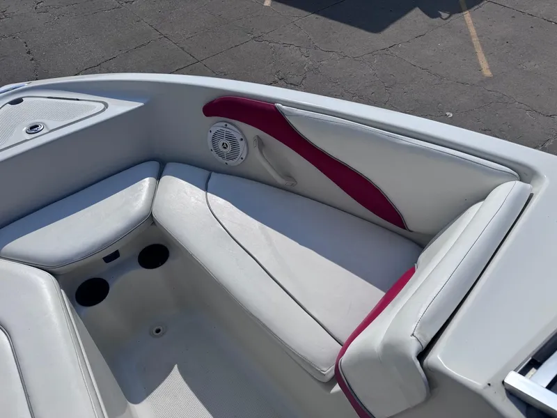 Slide: The Image of 2006 Sugar Sand Oasis boat interior with white and red seating, cup holders, and speaker. - 12