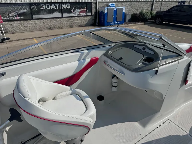 Slide: The Image of 2006 Sugar Sand Oasis boat interior with white and red seating, dashboard, and windshield. - 9