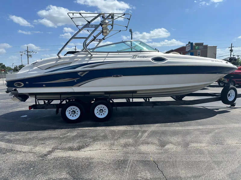 Slide: The Image of 2002 Sea Ray 270 SSI boat on trailer under clear sky. - 1