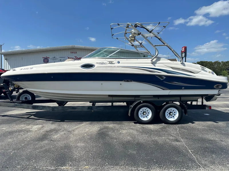 Slide: The Image of 2002 Sea Ray 270 SSI boat on trailer, parked outdoors under clear sky. - 3