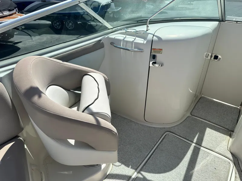 Slide: The Image of Interior of 2002 Sea Ray 270 SSI boat with beige seating and carpeted flooring. - 5