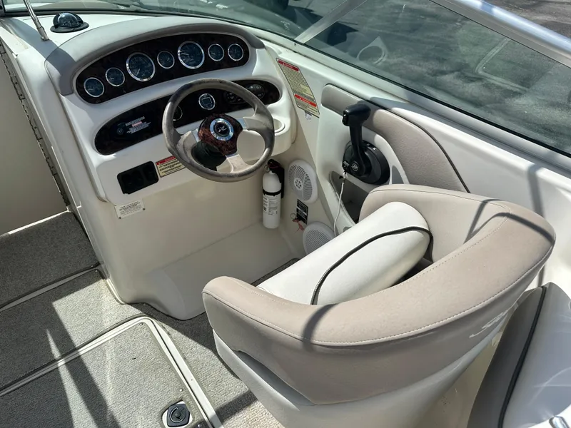 Slide: The Image of 2002 Sea Ray 270 SSI boat cockpit with steering wheel and controls. - 6
