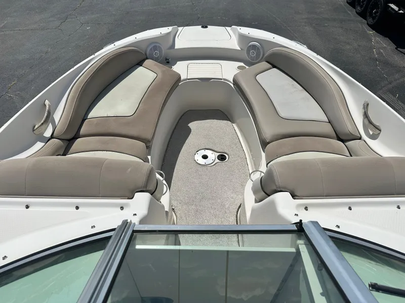 Slide: The Image of 2002 Sea Ray 270 SSI boat interior with cushioned seating and speakers. - 8