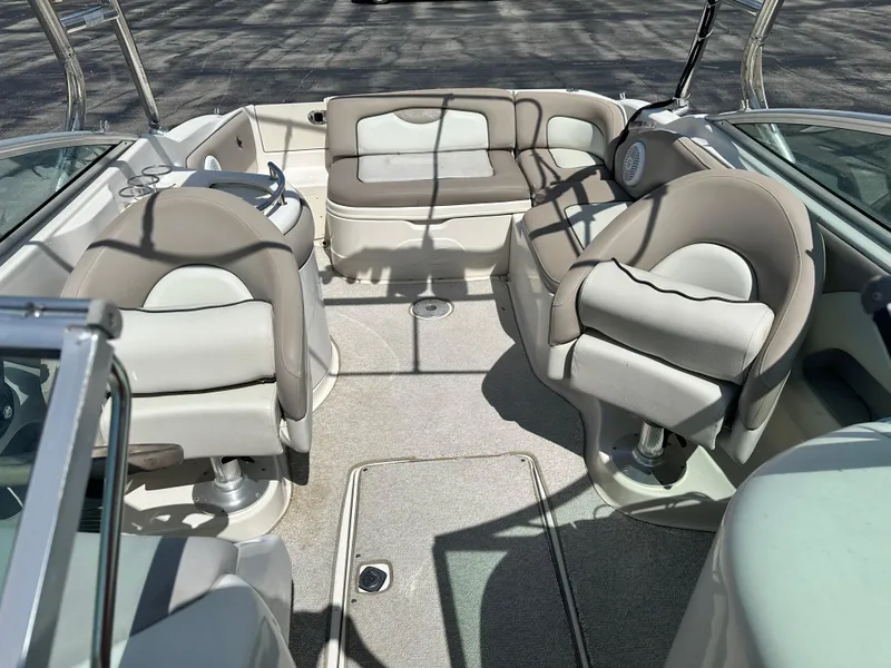 Slide: The Image of Interior of 2002 Sea Ray 270 SSI boat with beige seating and steering wheel. - 9