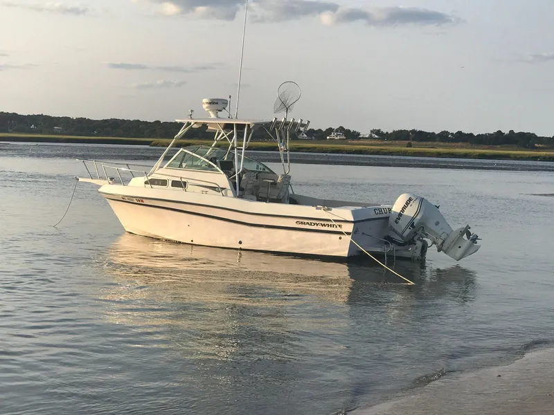 The Image of Grady-White 232 Gulfstream WA 2000 boat anchored in shallow water at sunset. - 0