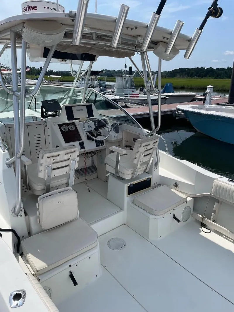 Slide: The Image of 2000 Grady-White 232 Gulfstream WA boat interior with seating and controls. - 10