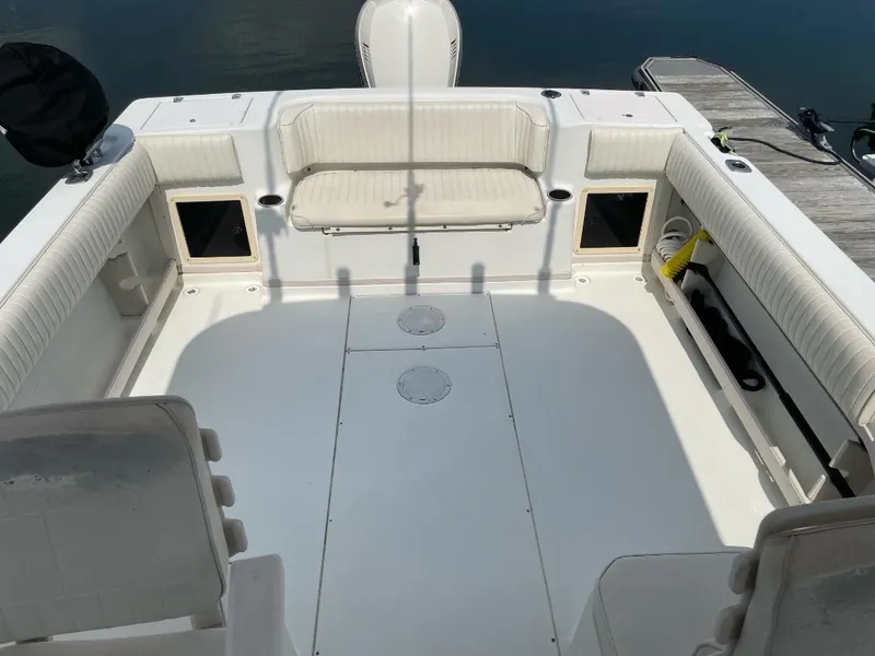 Slide: The Image of 2000 Grady-White 232 Gulfstream WA boat interior with spacious seating and clean deck. - 14