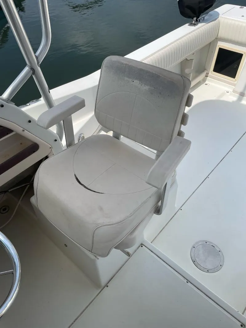 Slide: The Image of Grady-White 232 Gulfstream WA 2000 boat seat, white upholstery, on deck. - 16