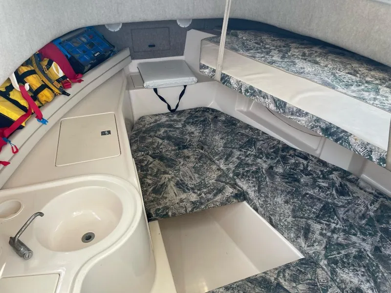 Slide: The Image of 2000 Grady-White 232 Gulfstream WA cabin interior with sink, seating, and life jackets. - 18