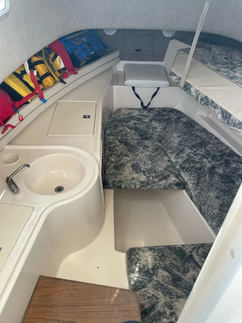 Slide: The Image of 2000 Grady-White 232 Gulfstream WA cabin interior with seating and life jackets. - 19