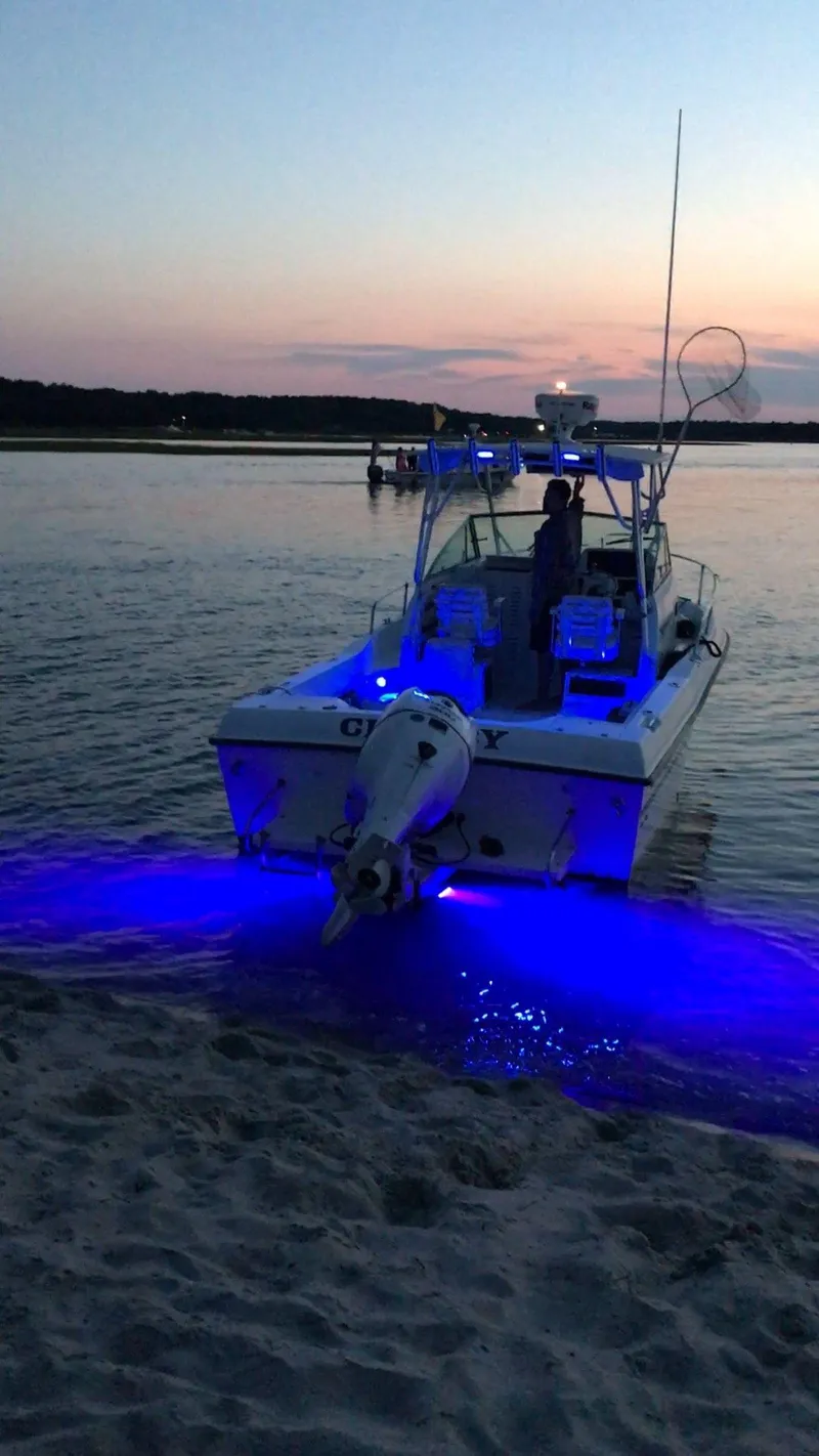 Slide: The Image of Grady-White 232 Gulfstream WA 2000 boat with blue underwater lights at sunset. - 21
