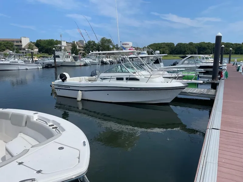 Slide: The Image of 2000 Grady-White 232 Gulfstream WA boat docked in a marina. - 3