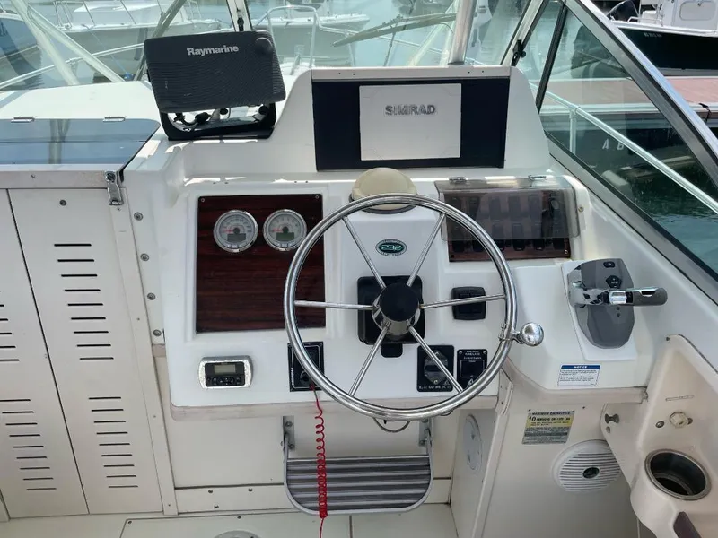 Slide: The Image of Grady-White 232 Gulfstream WA 2000 boat helm with steering wheel and navigation equipment. - 7